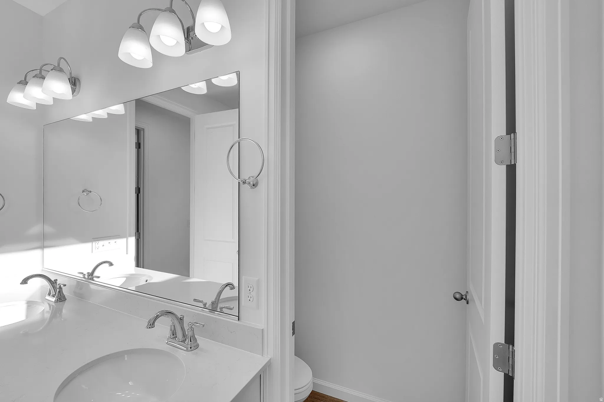 Dual vanity with undermount sinks, chrome fixtures, and a large wall-mounted mirror