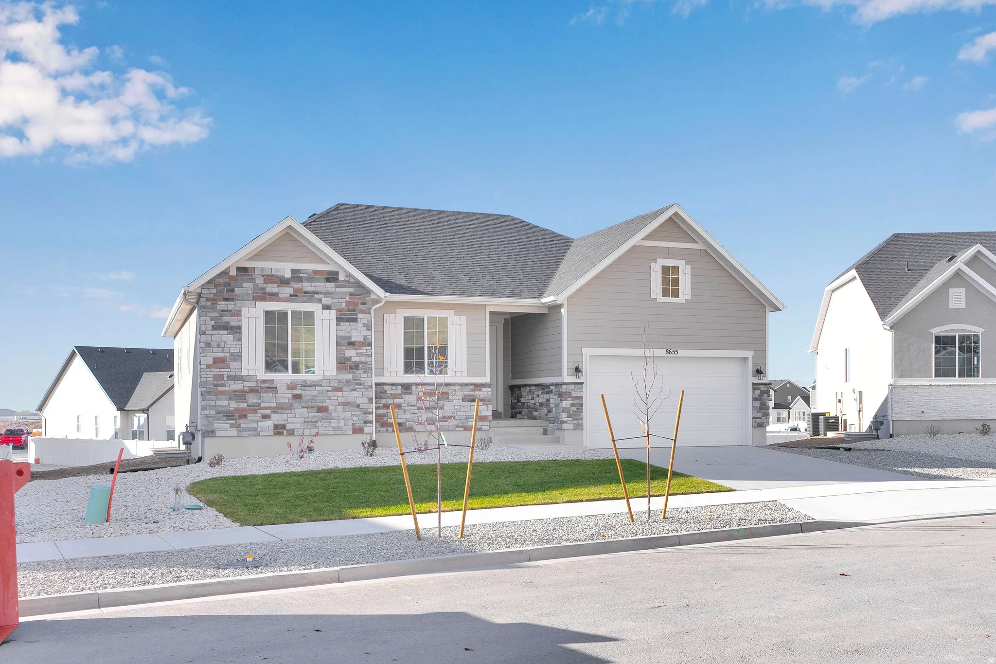 Stone veneer and siding exterior with a dark shingle roof