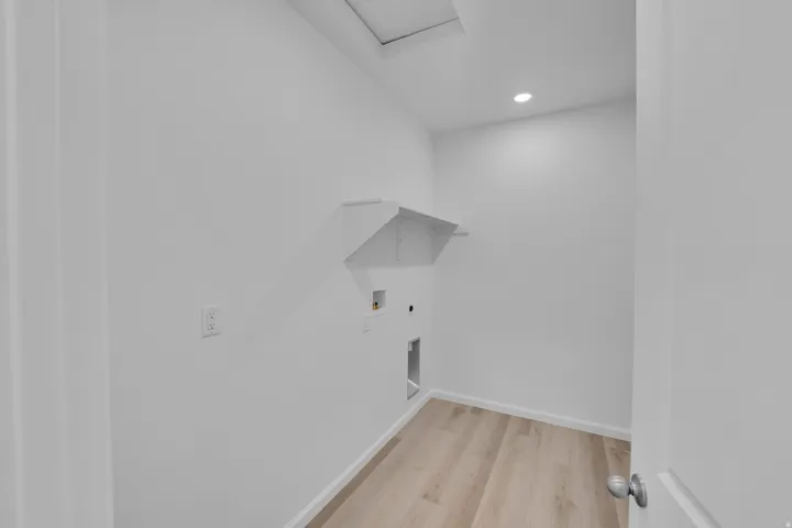 Recessed lighting, wood-finish flooring, built-in wall shelving, and utility hookups