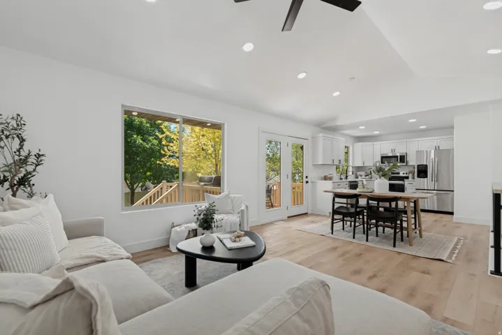 Open-concept living space featuring wood-finish flooring, recessed lighting, and a contemporary ceiling fan