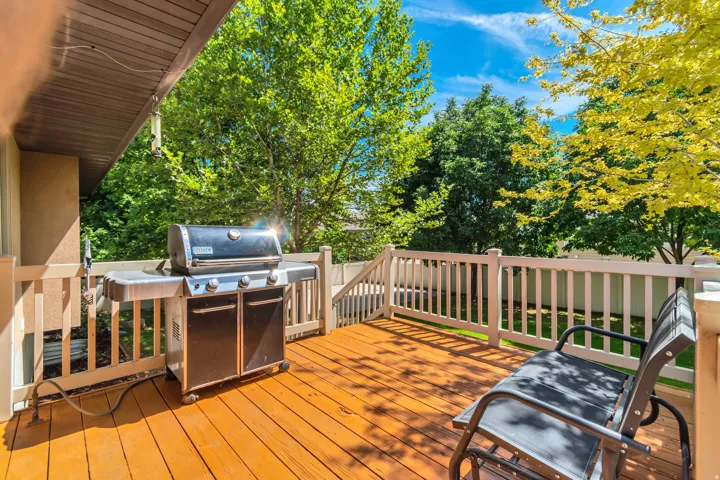 Wood-finish deck with white spindle railings and a slatted wood ceiling