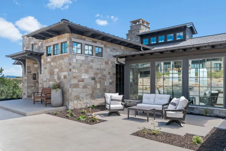 Stone exterior construction with a multi-pane window system and dormer roof detail