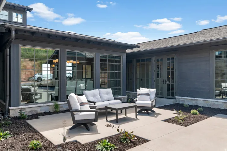 Expansive concrete patio with integrated landscaping