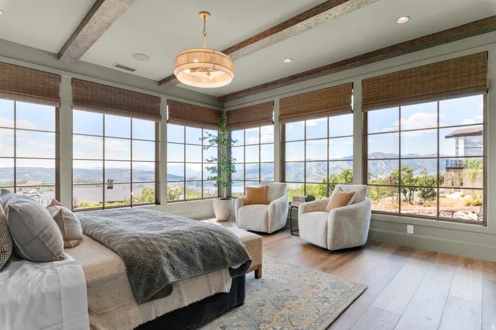 Hardwood-finish flooring with expansive picture windows featuring mountain scenery