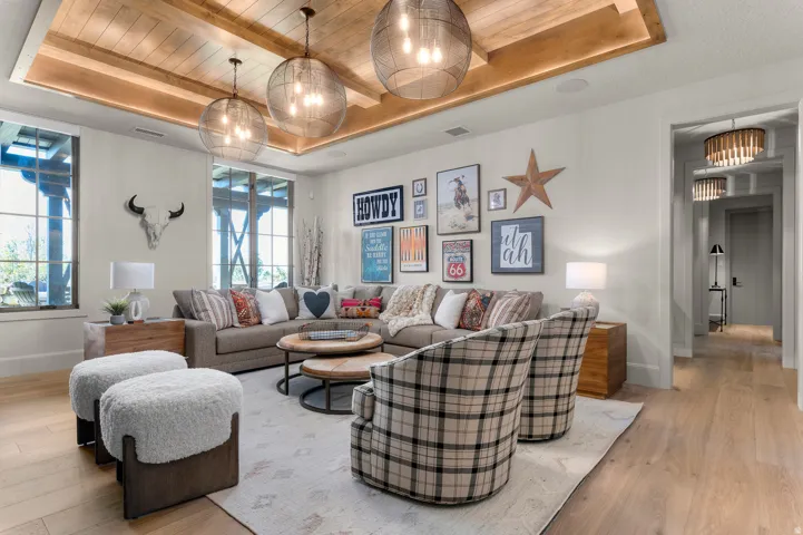 Recessed wood-clad tray ceiling with three suspended spherical light fixtures