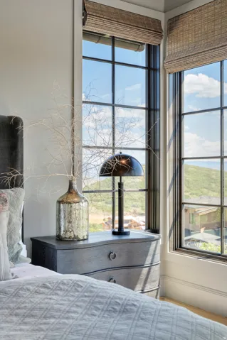 Corner window configuration with black grids and woven blinds