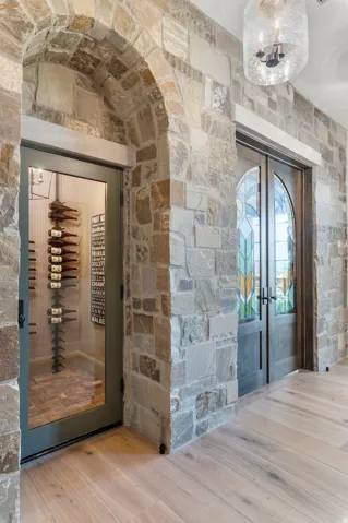 Stone archway with an adjacent glass-paneled door