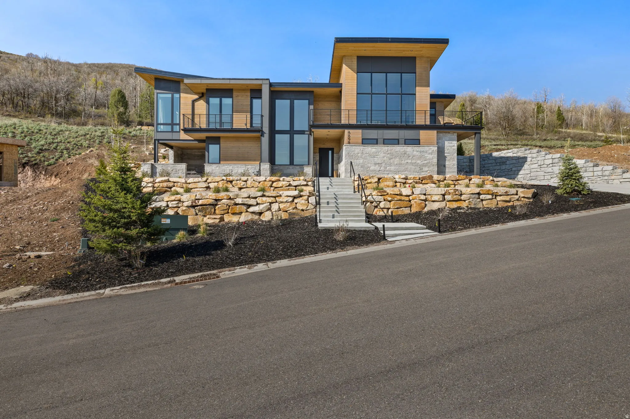 Modern architectural exterior with wood paneling and stone accents