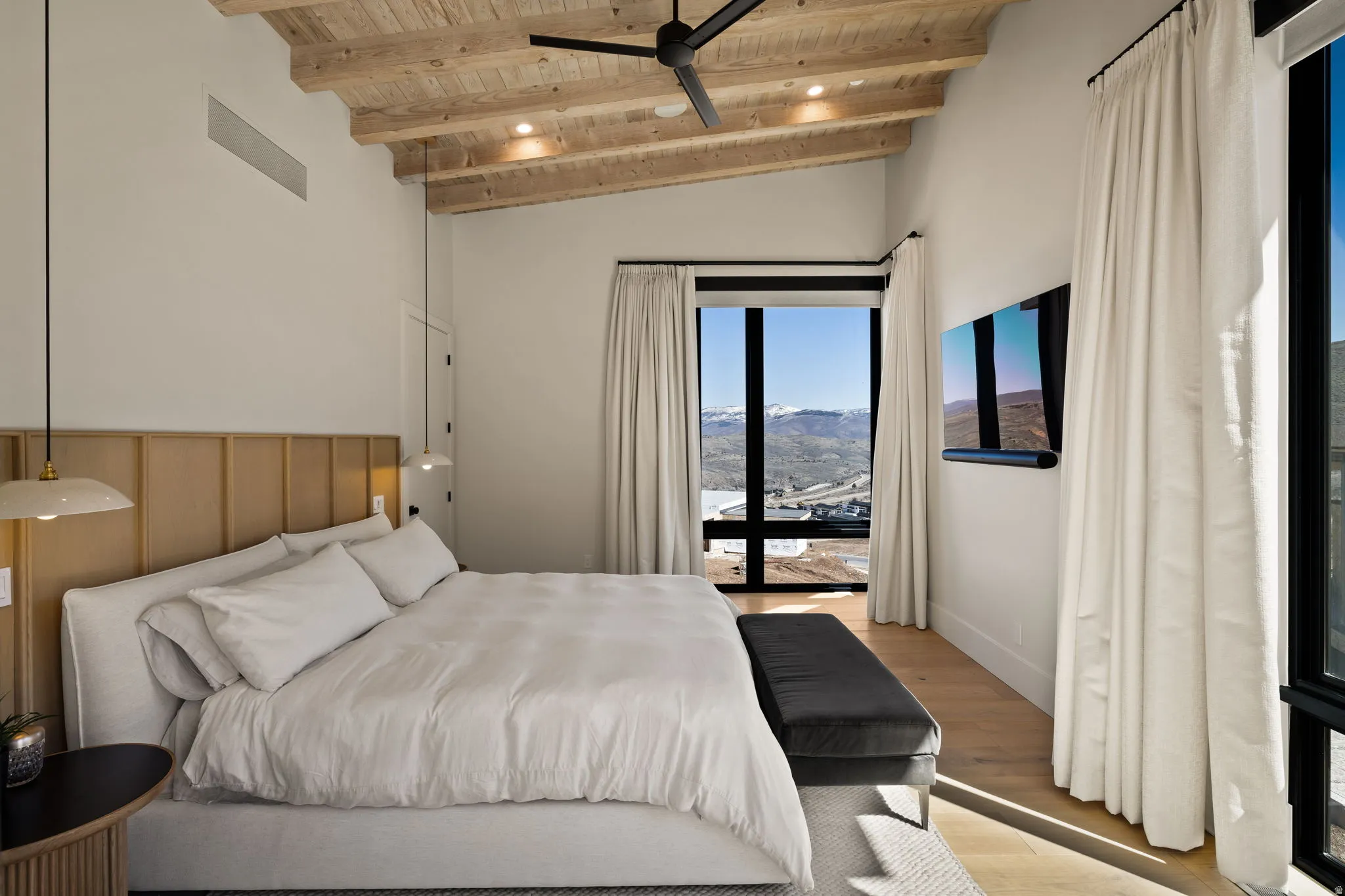 Vaulted wood-plank ceiling with recessed lighting and a ceiling fan