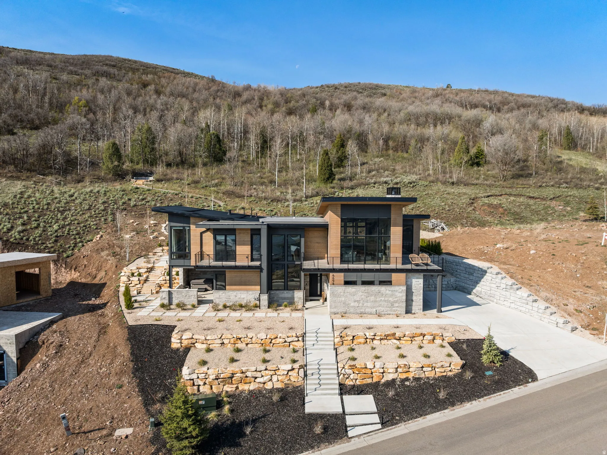 Modern architectural exterior with a flat roofline, extensive window placement, and multiple balconies