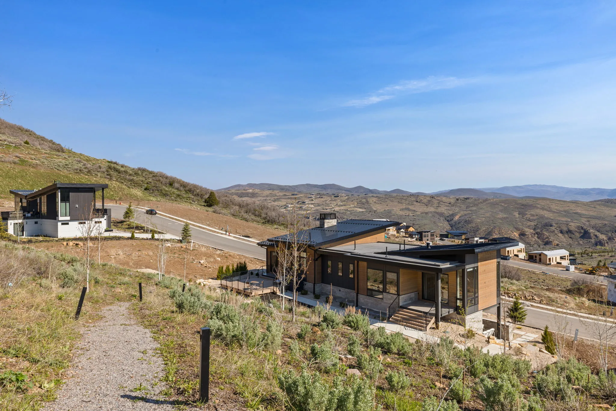 Modern architectural exterior with a flat roof, large windows, and a multi-level design