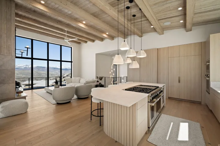 Wood-finish flooring throughout, vaulted ceiling with exposed wood beams, and a full-height window wall
