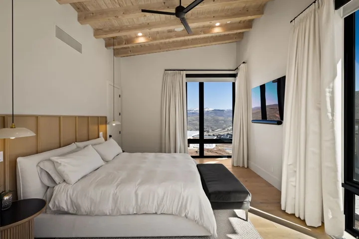 Vaulted wood-plank ceiling with recessed lighting and a ceiling fan