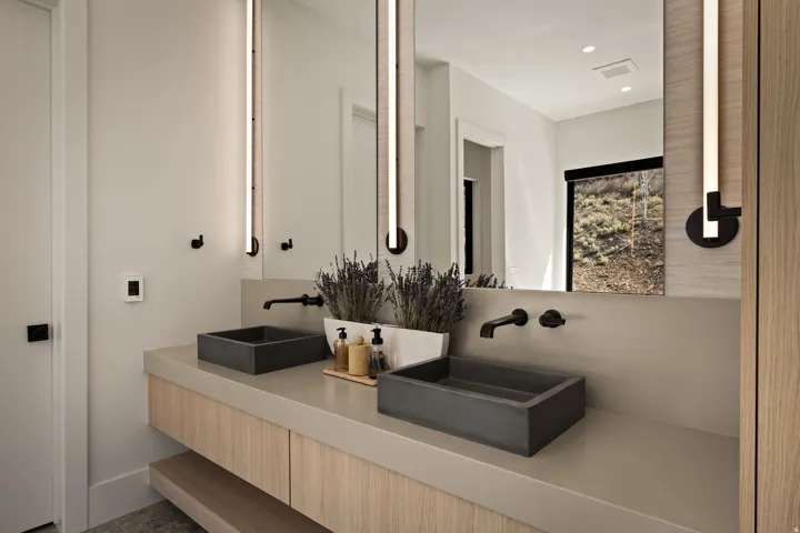 Dual rectangular vessel sinks with matte black wall-mounted faucets