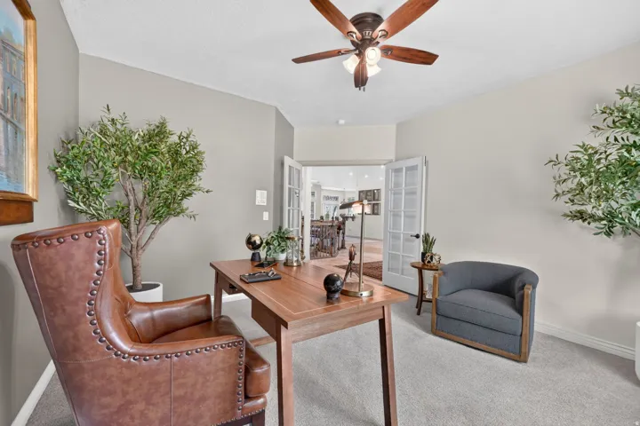Neutral tone wall paint, recessed lighting, ceiling fan with integrated lighting, French doors, and carpet flooring