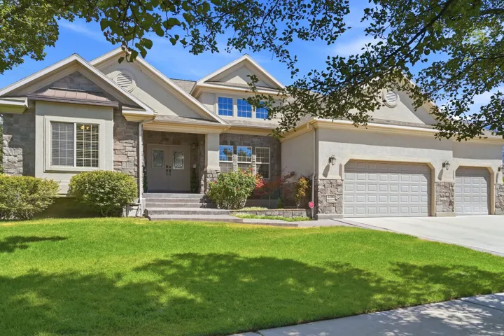 Stone and stucco exterior with a multi-gabled roofline