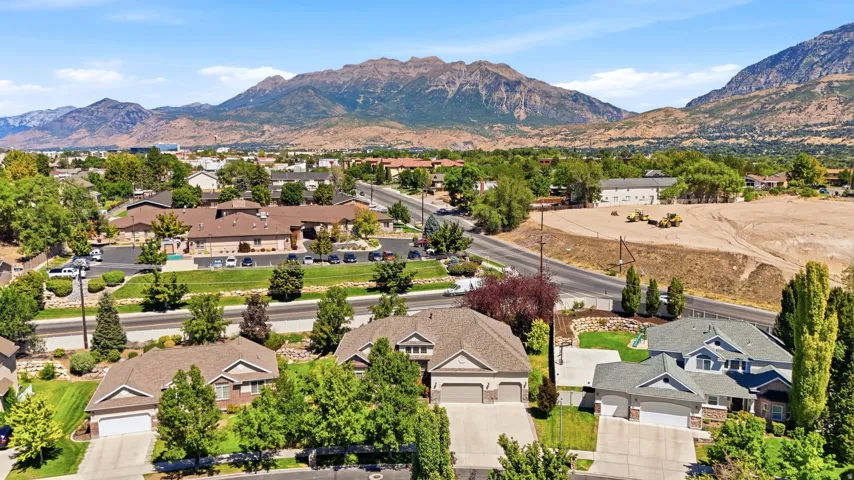 Aerial perspective showcasing the residential area with surrounding infrastructure and mountain backdrop