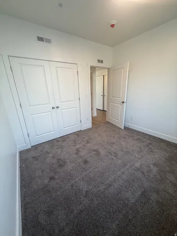 Plush grey carpeting, white interior doors, and crisp white walls