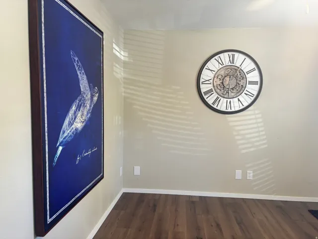 Wood-finish flooring with neutral wall tones and white trim