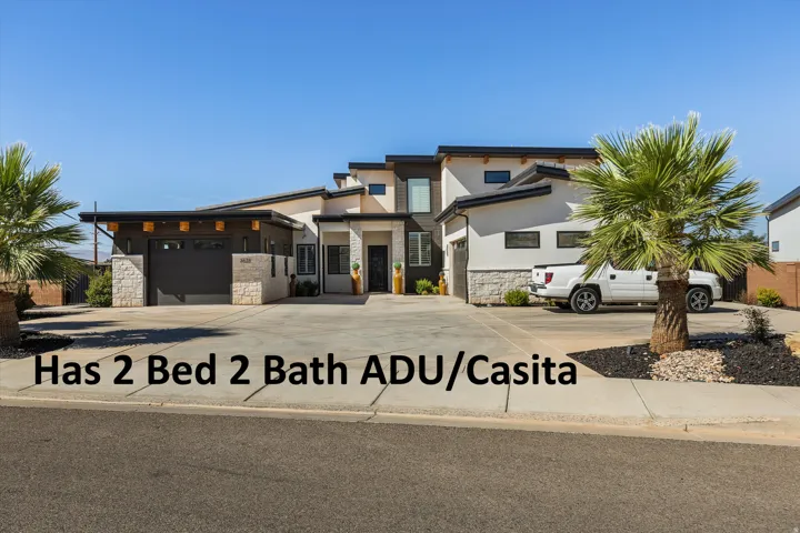 Contemporary exterior featuring a multi-level design, attached two-car garage, stone and stucco facade, and a concrete driveway
