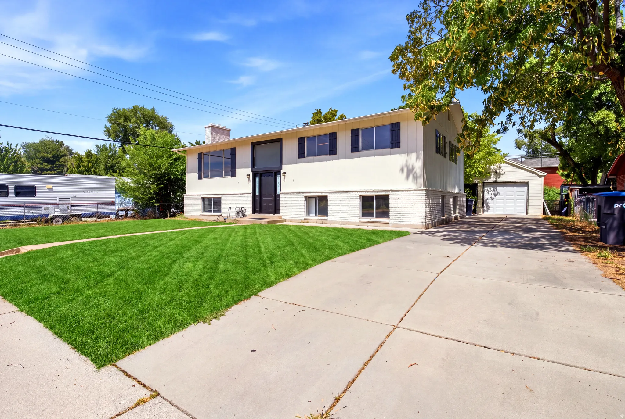 Split-level residence featuring a concrete driveway and an attached garage
