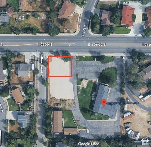 Aerial View of Property. The property highlighted in red, situated along a public roadway