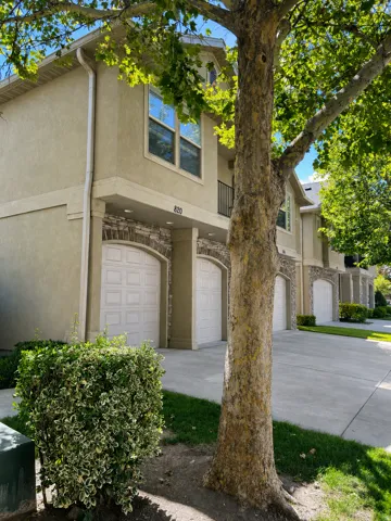 Stucco exterior with stone accents and arched garage door. New Spring-and-cable garage door package backed by a 10-year warranty