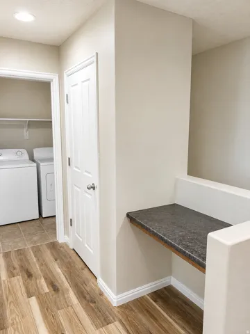 Laundry area with tile flooring and shelving