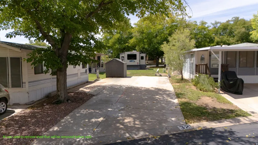 Mature shade trees and expansive asphalt driveway provide excellent outdoor space throughout this mobile home community lot