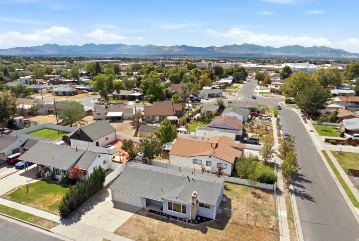 Residential neighborhood with established homes, mature landscaping, and mountain backdrop