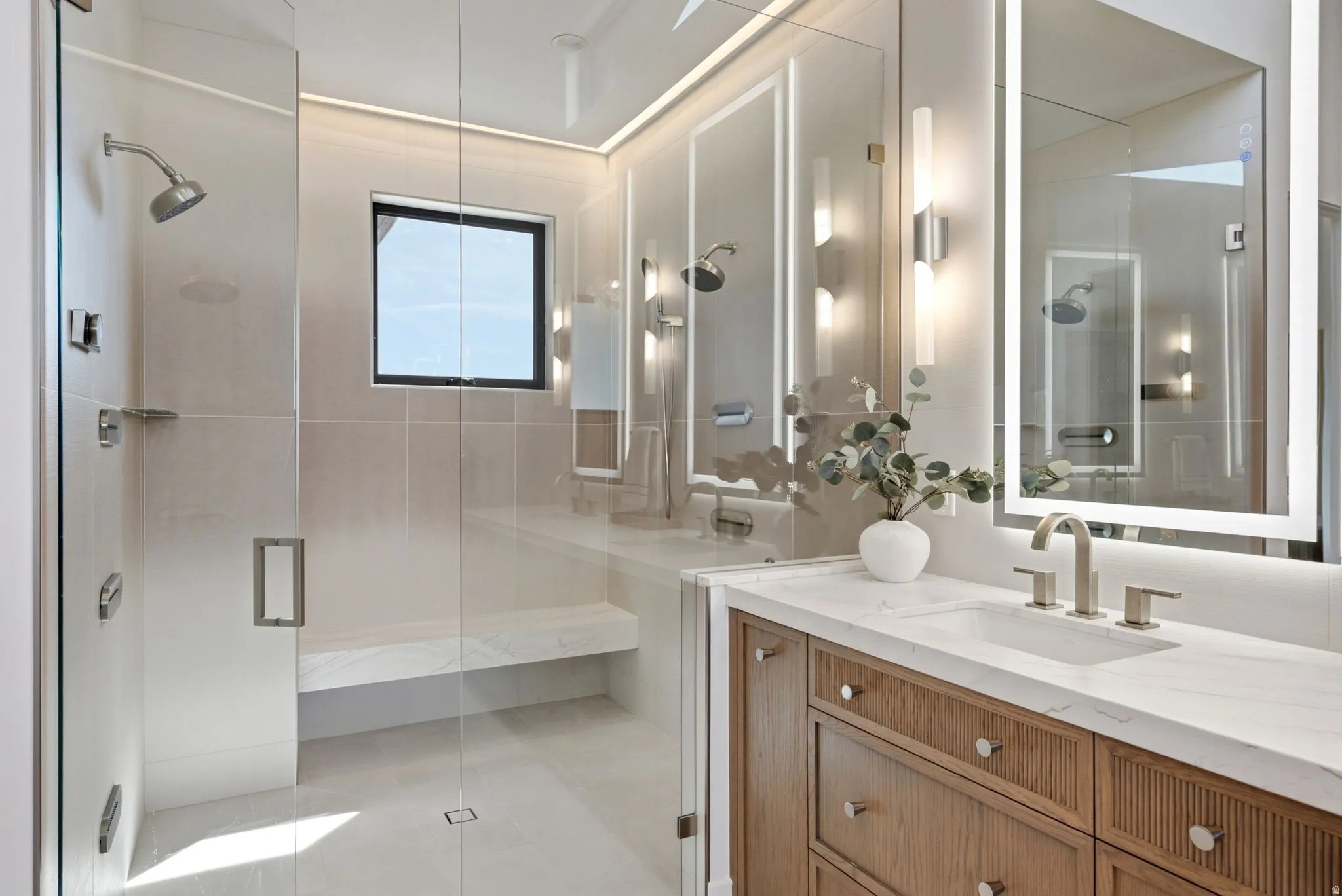 Glass-enclosed shower with a built-in bench, square window, and rainfall showerhead