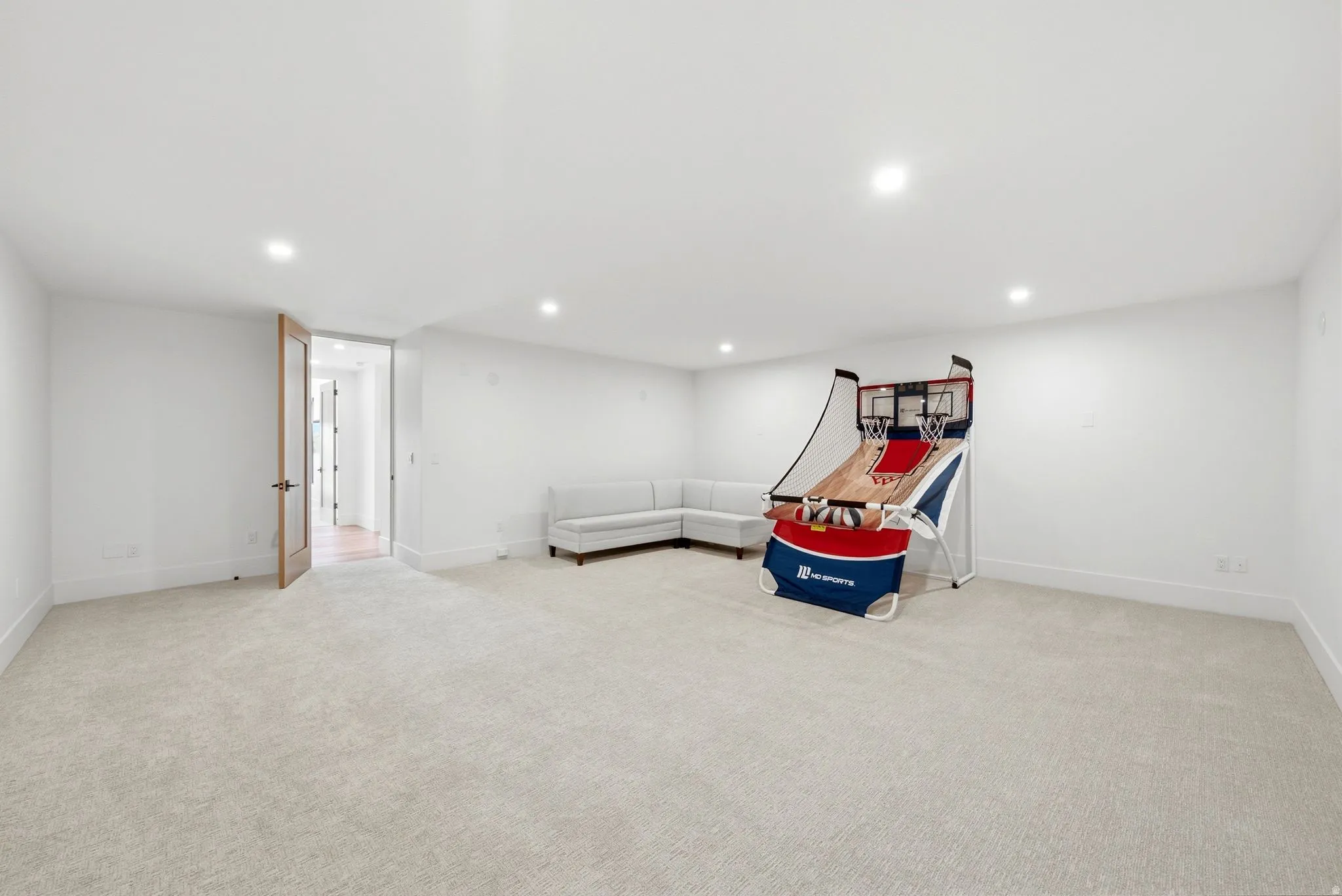 Spacious Flex Room room featuring neutral carpeting, recessed lighting, and a wood-finish interior door