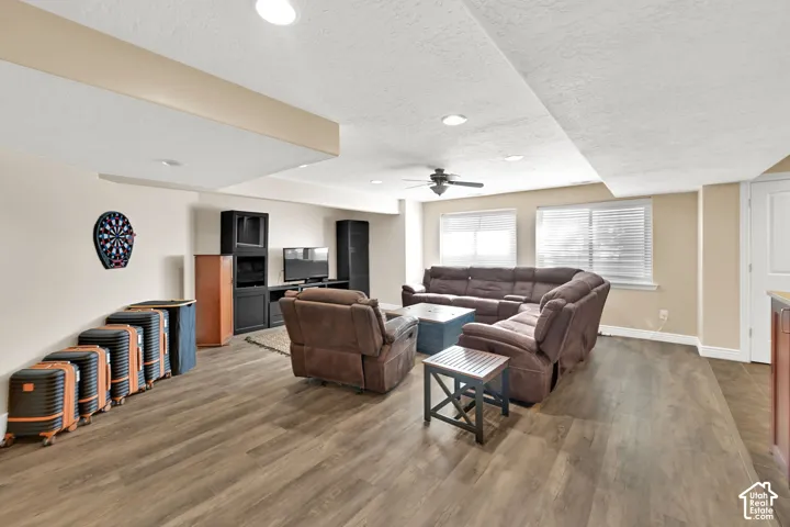 Spacious room featuring NEW LVP flooring, recessed lighting, and multiple windows with blinds