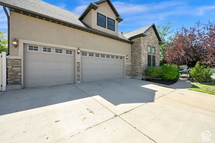 Stone and stucco exterior featuring four car garage