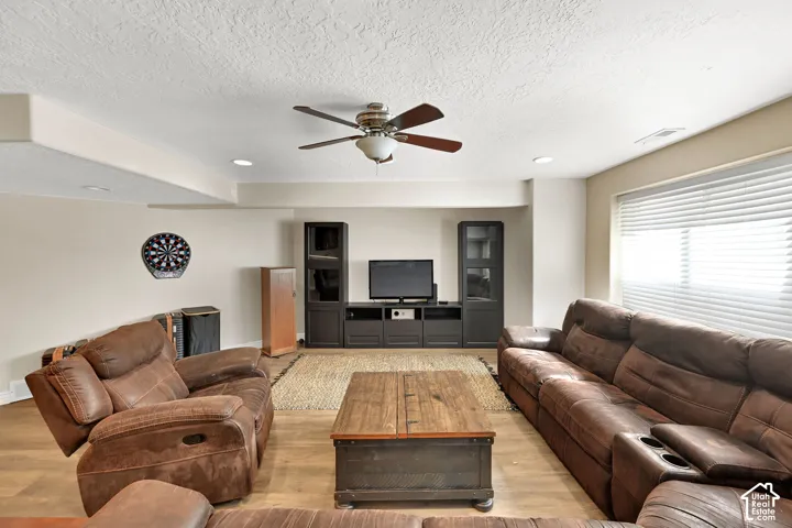 Recessed ceiling lighting, LVP flooring, ceiling fan with integrated light, window with blinds