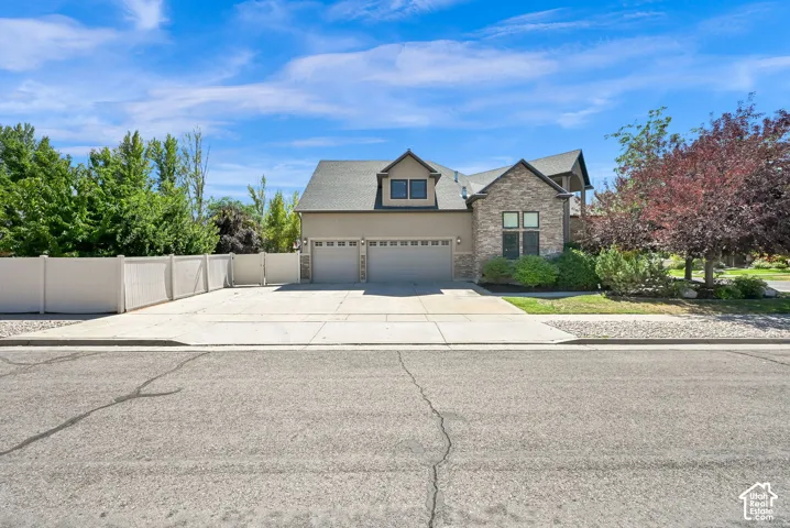 Stone and stucco exterior with dormer windows 4 car garage and RV parking