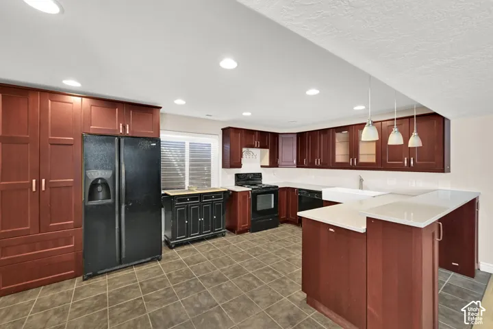 ADU Kitchen featuring rich wood cabinetry, white countertops, tile flooring, and recessed lighting