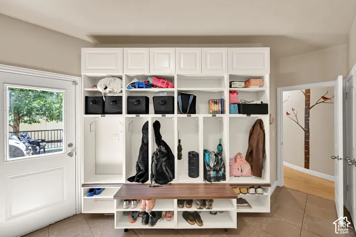 Built-in storage cabinetry with a wood  bench and integrated shelving
