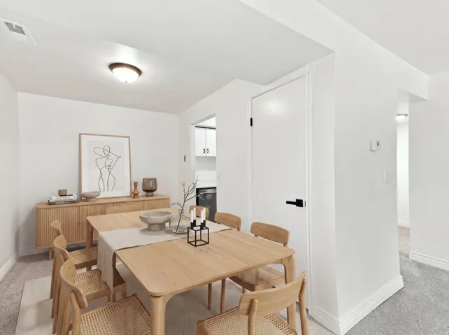 Warm wood-finish flooring, built-in ceiling light fixture, white walls, and white trim