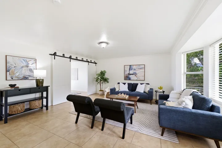 Tile flooring, white walls, and a bay window with blinds