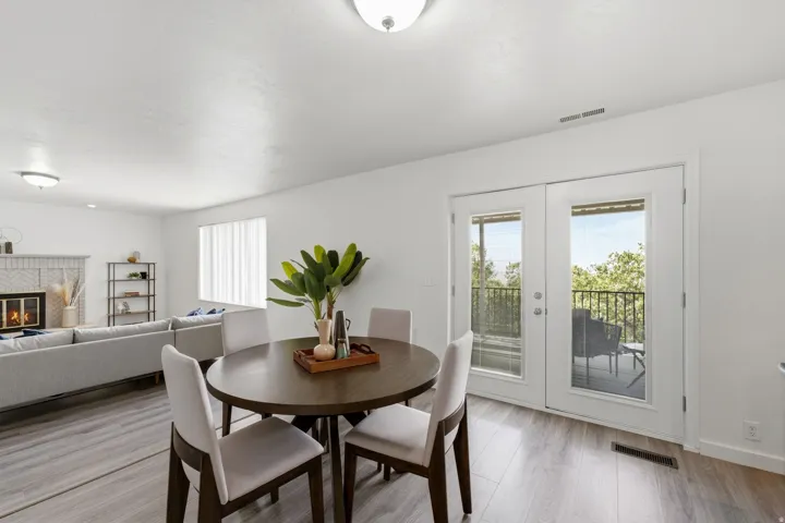 Wood-finish flooring throughout, white walls, and a recessed window