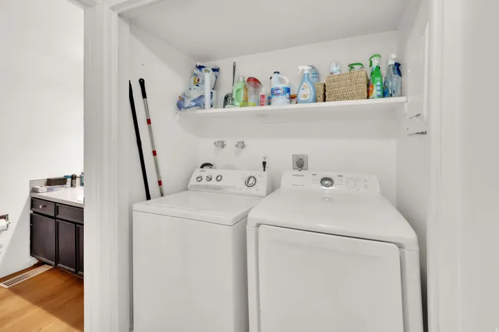 Dedicated laundry area with a white built-in shelf