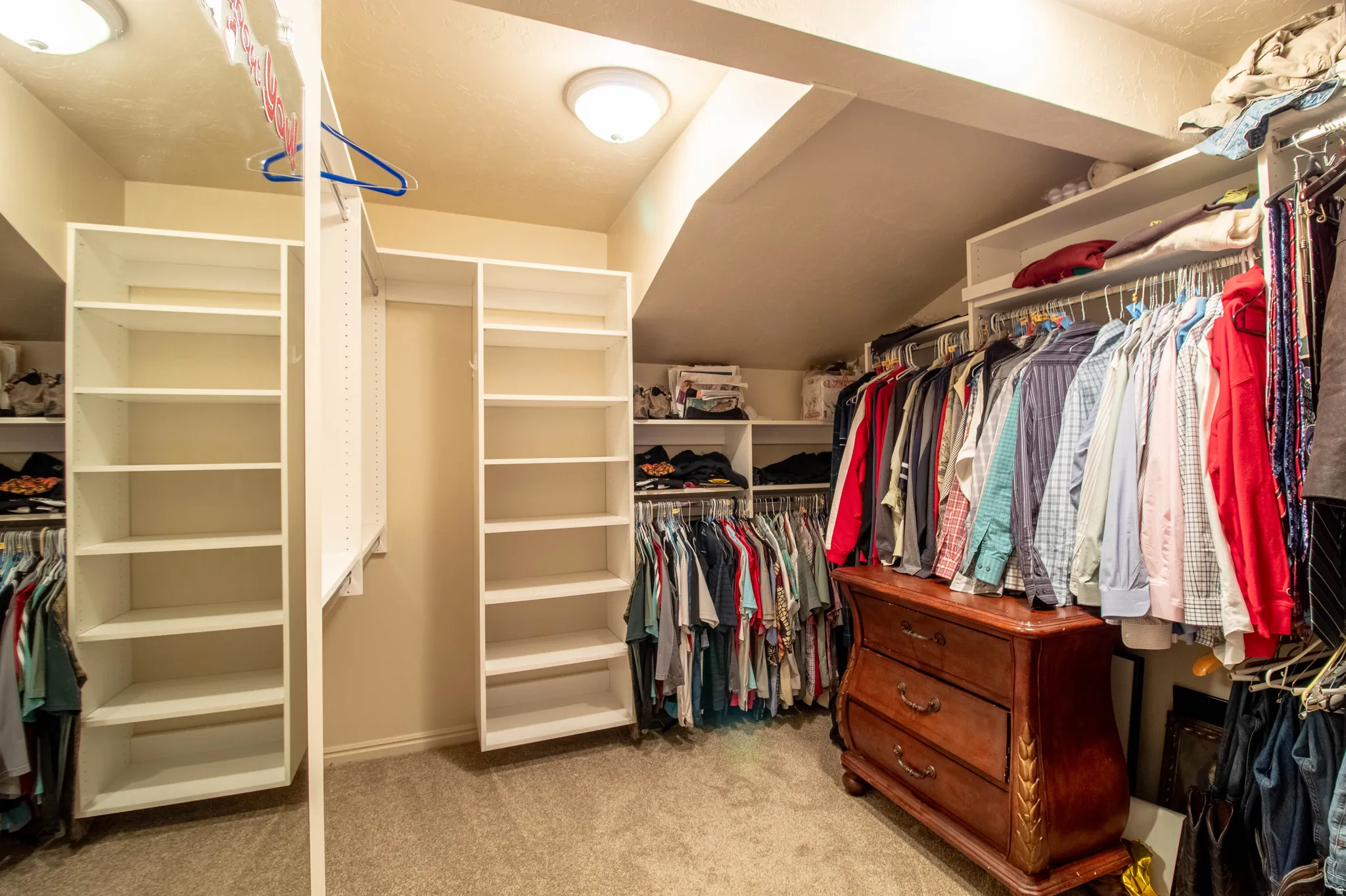 Custom closet system with multiple shelving units, hanging rods, and built-in storage