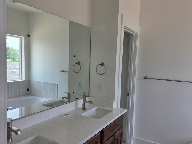 Dual vanity with light-toned countertop and integrated sinks
