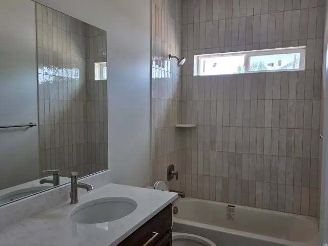 Vanity with undermount sink, countertop, and brushed nickel faucet