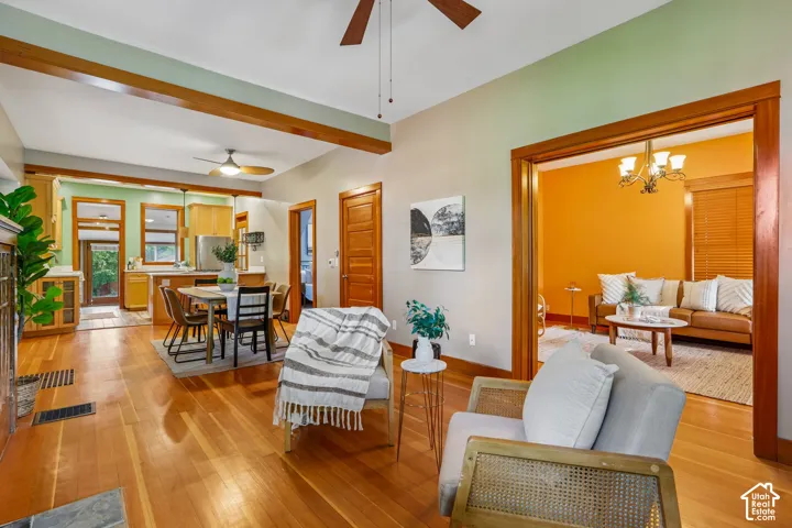 Wood-finish flooring throughout, featuring a kitchen with light wood cabinetry and stainless-steel appliances