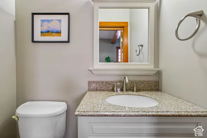 White vanity with a neutral-toned countertop, undermount sink, and brushed nickel faucet