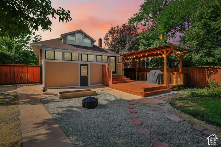 Expansive deck with a pergola and string lighting