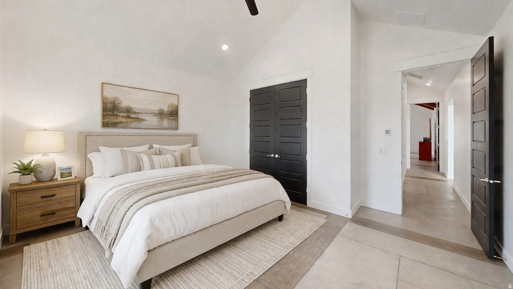 This is an Ai enhanced Photo. Vaulted ceiling, recessed lighting, ceiling fan, dark panel doors, light-toned flooring