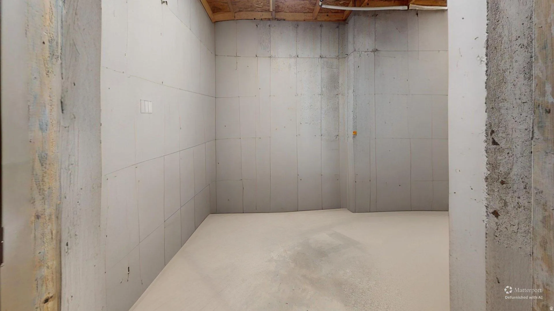 This is an Ai enhanced Photo. Finished basement space with concrete walls and exposed ceiling joists